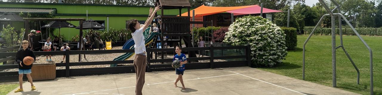 Basketball court and playground in front of Julians Berry Farm Cafe